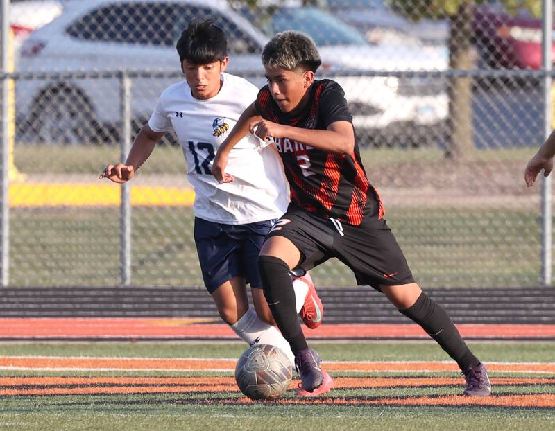 DeKalb's Jonathan Contreras pushes the ball ahead of Guilford's Juan Martinez during their game Thursday, Sept. 18, 2025, at Dekalb High School.