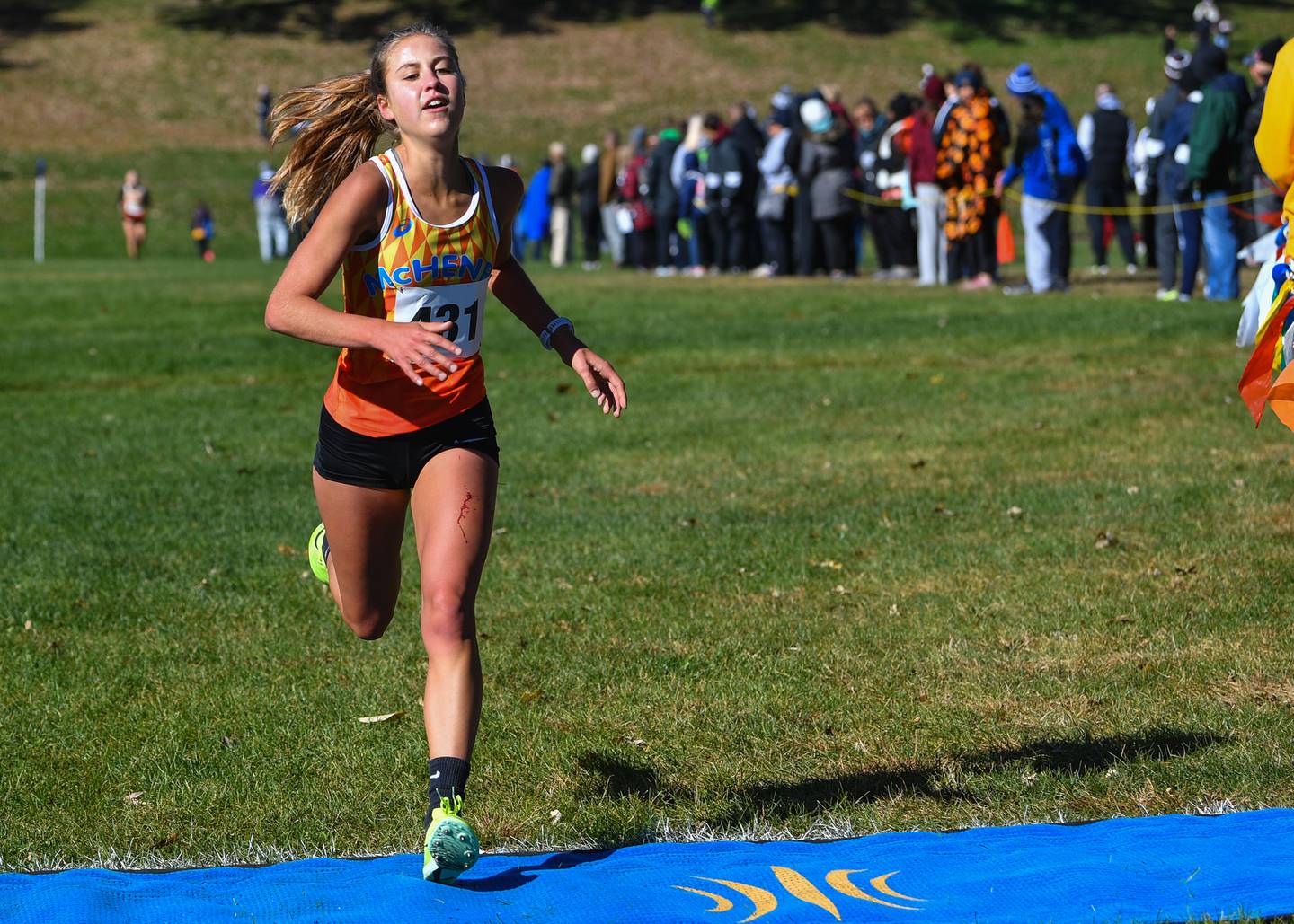 McHenry's Danielle Jensen crosses the finish line to finish fourth in the Fox Valley Conference girls cross country meet at Veteran Acres Park on Saturday, Oct. 15, 2022 in Crystal Lake.