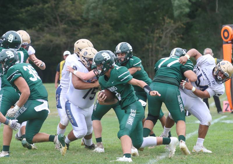 St. Bede quarterback AJ Hermes (center) runs the ball against Marquette on Saturday, Sept. 28, 2024 at St. Bede Academy.
