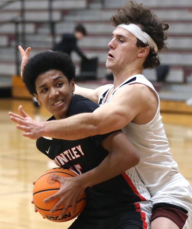 Huntley's Isaac Muze tries to drive to the basket against Prairie Ridge's Luke Vanderwiel during a Fox Valley Conference boys basketball game on Wednesday, Jan. 21, 2026, at Prairie Ridge High School in Crystal Lake.