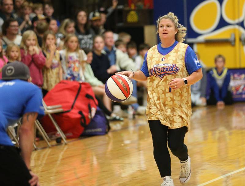Larissa Pinter, Physical Education instructor at Logan Jr. High School, dribbles the ball down the floor during the Harlem Wizards event on Tuesday, Oct. 28, 2025 in Pannebaker Gymnasium at Logan Jr. High School in Princeton.