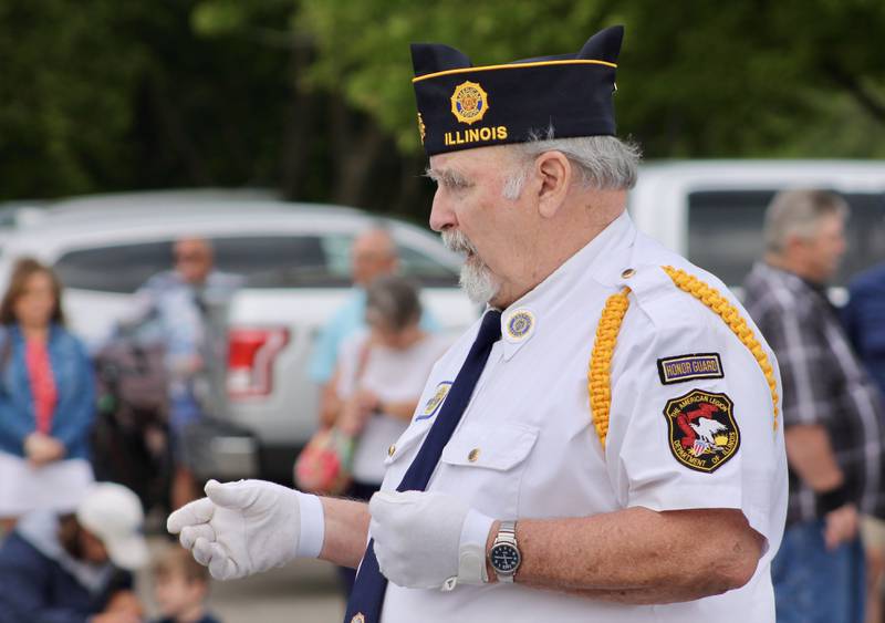 Wilbur Wildman provides instruction to honor guard taking part in the Memorial Day ceremony along the Rock River on Monday, May 29, 2023.