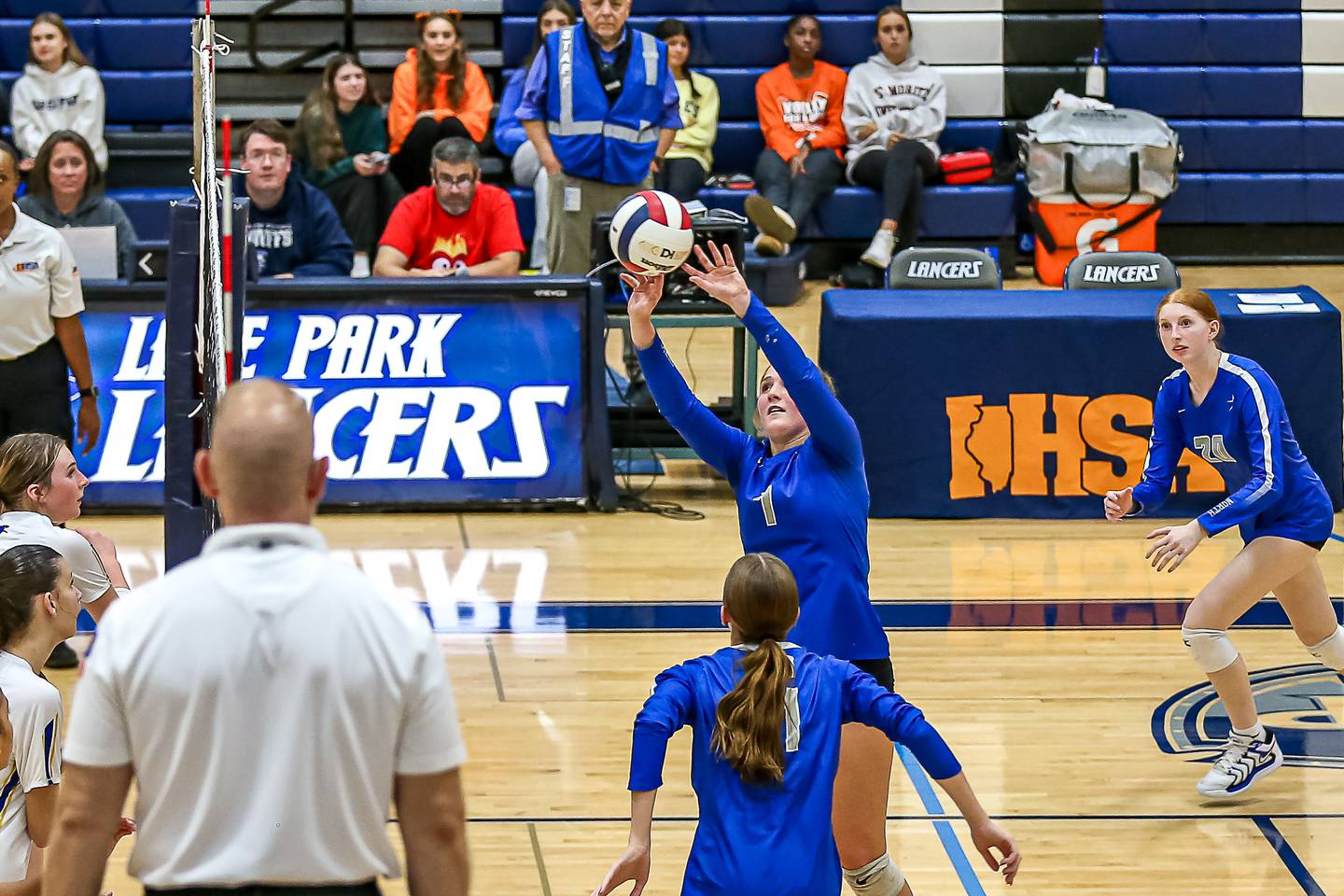 St. Charles North's Mia Mccall (7) sets a shot over the net during Class 4A Lake Park Regional final volleyball match between Wheaton North at St Charles North.  Oct 31, 2024  in Roselle.