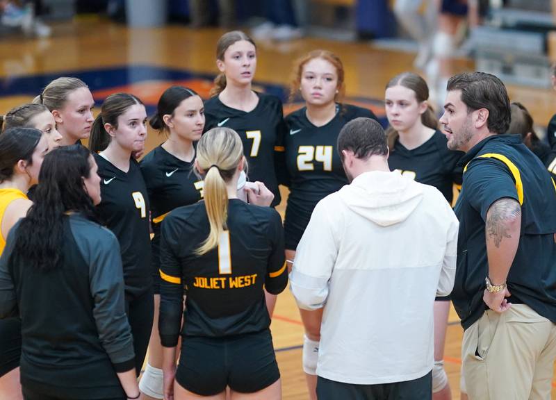 Joliet West's head coach Christopher Lincoln (right) talks to his players during a class 4A Oswego Sectional semifinal match at Oswego High School on Monday, Oct. 30, 2023.