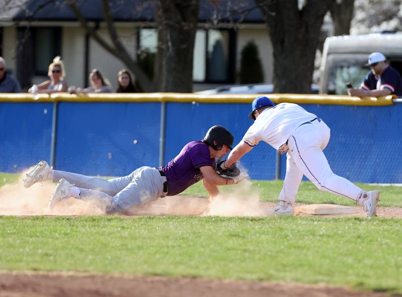 Lyons Township's Sam Viniard (37) tags Downers Grove North's Tommy Finley (15) for a pick-off during the boys varsity baseball game between Lyons Township and Downers Grove North high schools in Western Springs on Tuesday, April 11, 2023.