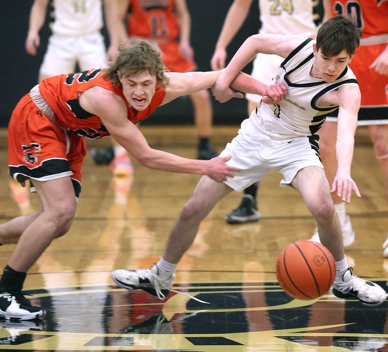 Sandwich's Austin Marks (left) and Sycamore's Jaxon Tierney go after a loose ball during their game Tuesday, Jan. 17, 2023, at Sycamore High School.