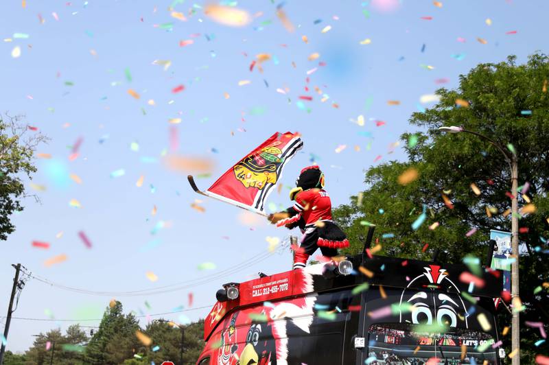 Chicago Blackhawks mascot Tommy Hawk rides on the roof of a truck during the 77th Annual La Grange Pet Parade on Saturday, June 3, 2023.