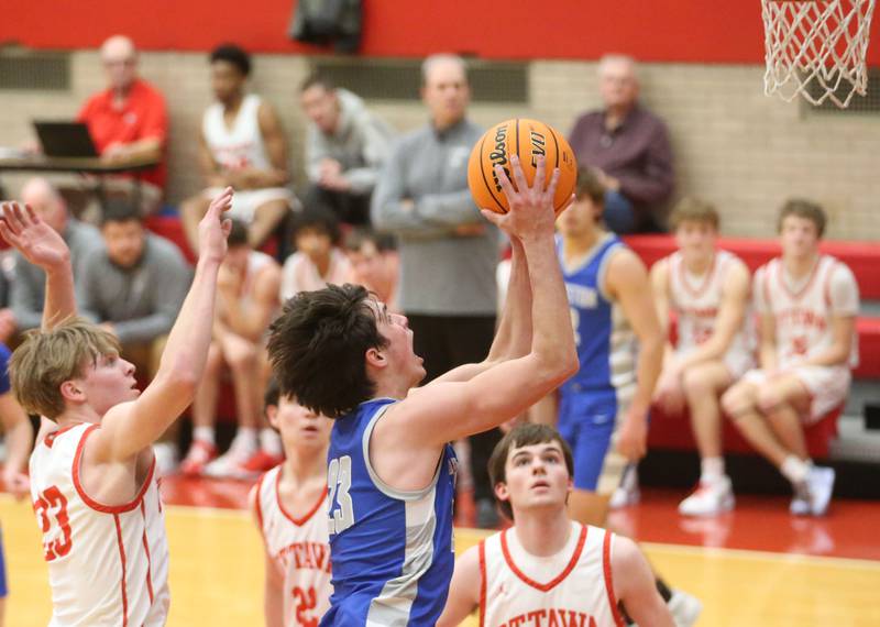 Princeton's Noah LaPorte eyes the hoop as  Ottawa's Owen Sanders and Seth Cooper defends on Monday, Feb. 3, 2025 in Kingman Gymnasium at Ottawa High School.