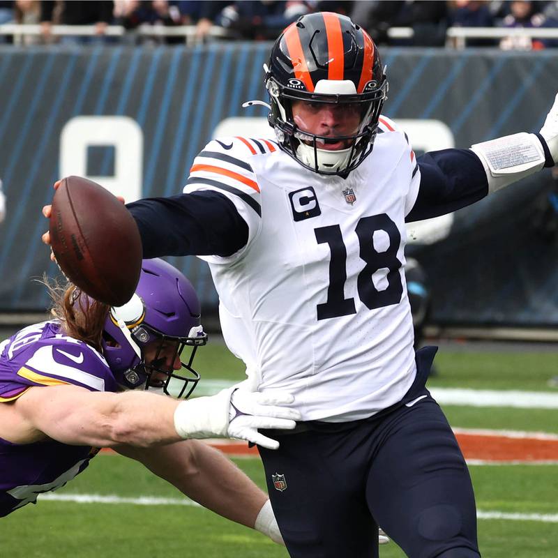 Chicago Bears quarterback Caleb Williams reaches to get a first down as Minnesota Vikings linebacker Andrew Van Ginkel tries to make the tackle during their game Sunday, Nov. 24, 2024, at Soldier Field in Chicago.