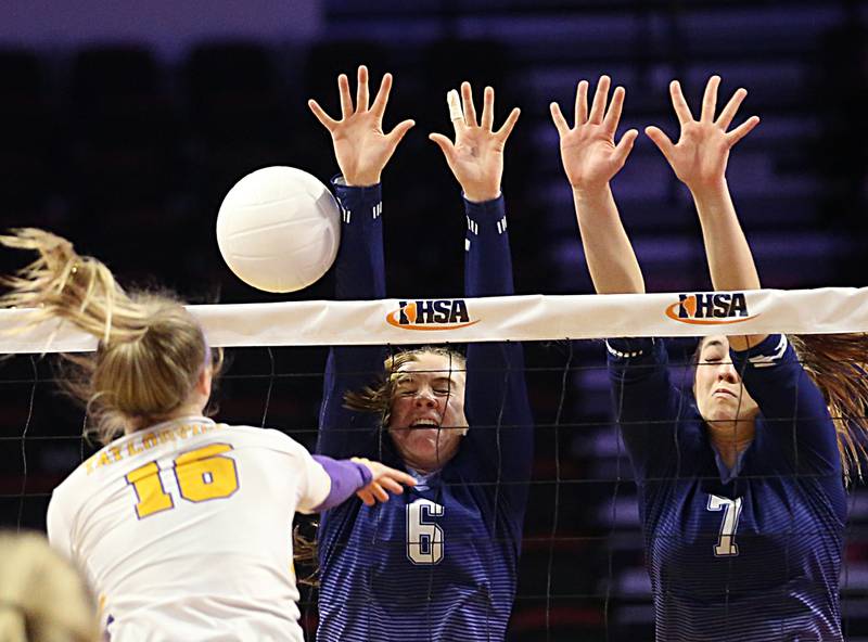 Taylorville's Addison Tarr (16) spike is blocked by Nazareth Academy's Kitty Sandt (6) and teammate Olivia Austin (7) in the Class 3A semifinal game on Friday, Nov. 11, 2022 at Redbird Arena in Normal.