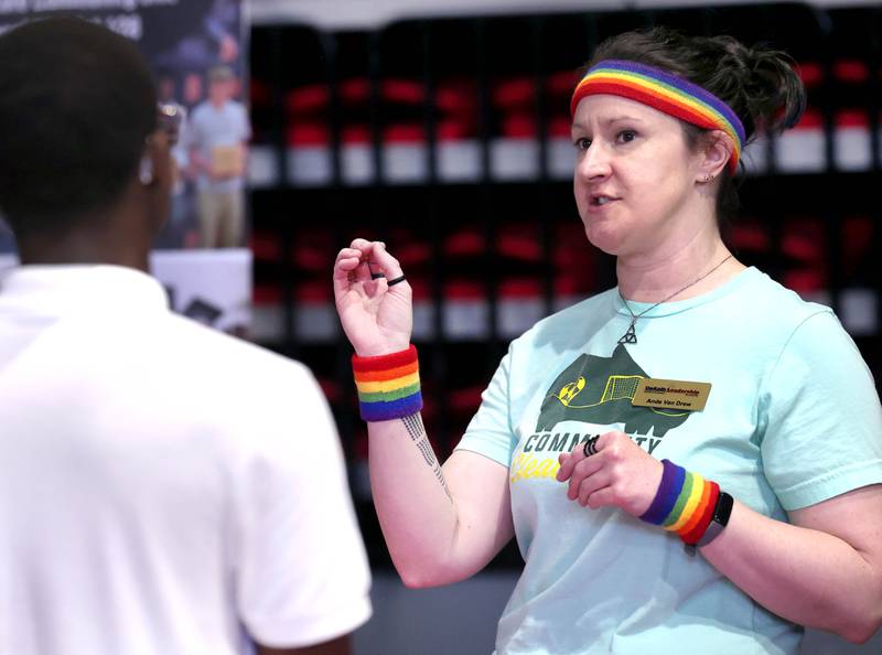 Ande Van Drew talks to an attendee at the DeKalb Chamber Leadership Academy booth Thursday, April 24, 2025, during the Local Showcase and Spring Show in the Convocation Center at Northern Illinois University in DeKalb.