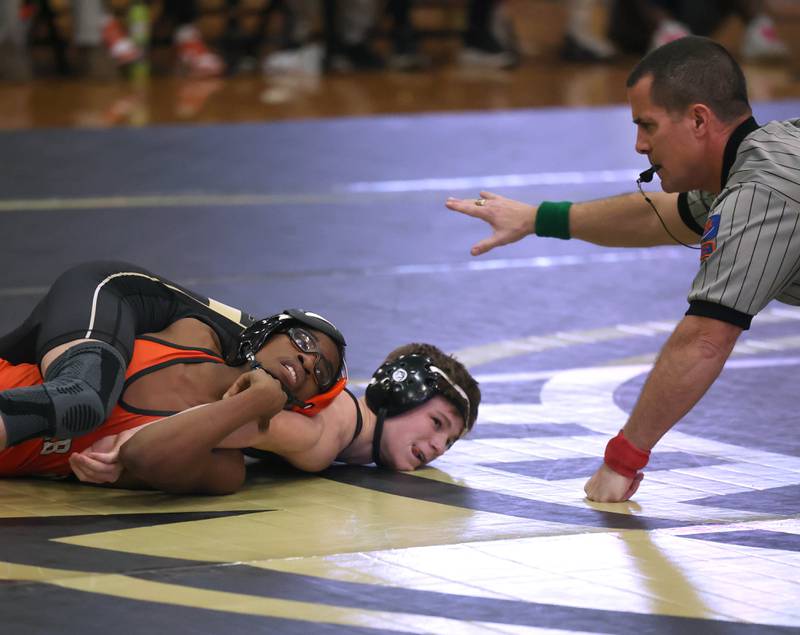 Sycamore’s Liam Schroeder scores points against DeKalb’s Jaden Bradley during their 113 pound match Friday, Jan. 16, 2026, at Sycamore High School.