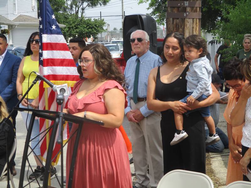 Karen Diaz Duenez, the widow of Staff Sgt. Jose Duenez Jr., speaks to the gathering at the ceremony dedicating Albert Avenue in Joliet in her husband's honor. Friday, July 11, 2025