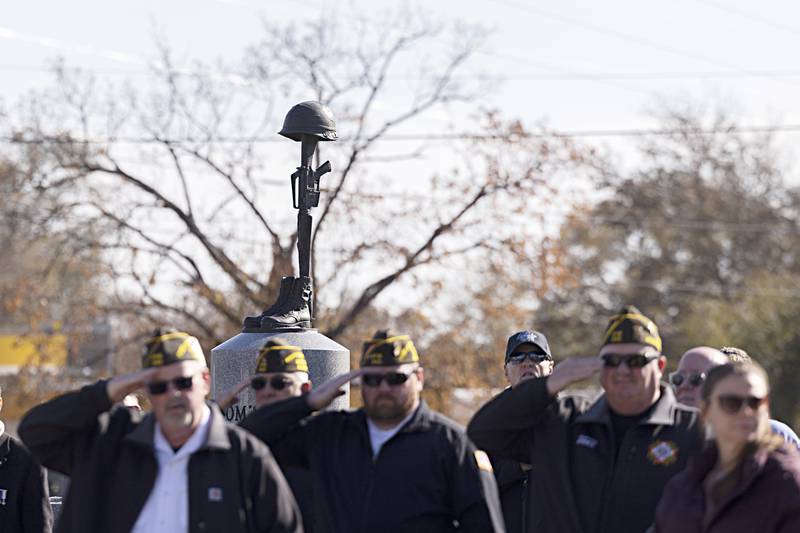 The battlefield cross memorial at Veterans Memorial Park Saturday, November, 11, 2023  in  Dixon is seen as local vets salute for the playing of the national anthem.