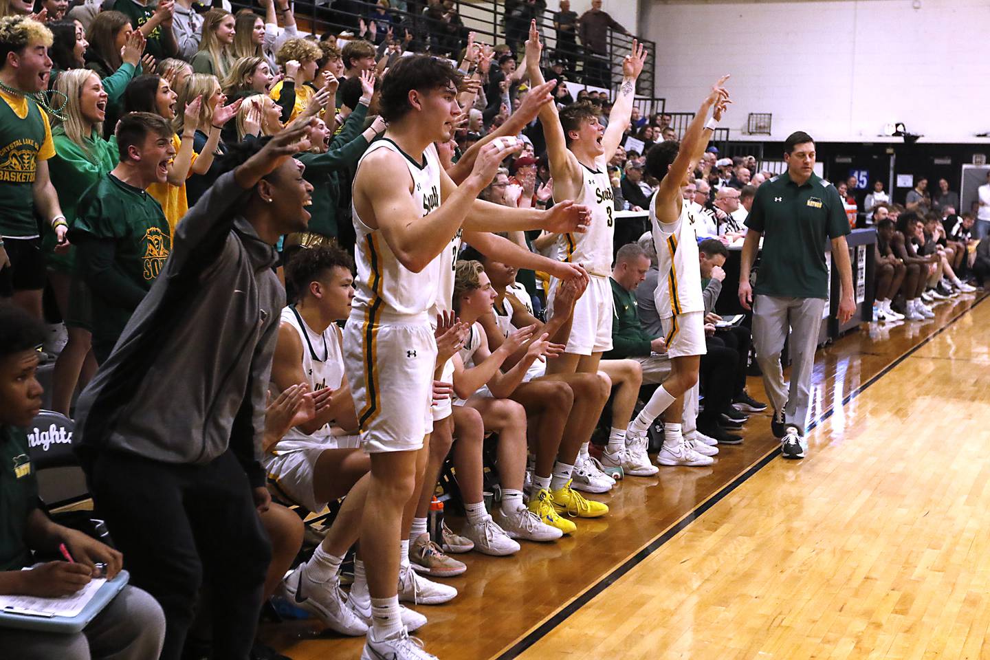 Crystal Lake South players celebrate a shot in the final minute of their d IHSA Class 3A Kaneland Boys Basketball Sectional championship game against Kaneland on Friday, March 1, 2024, at Kaneland High School in Maple Park.