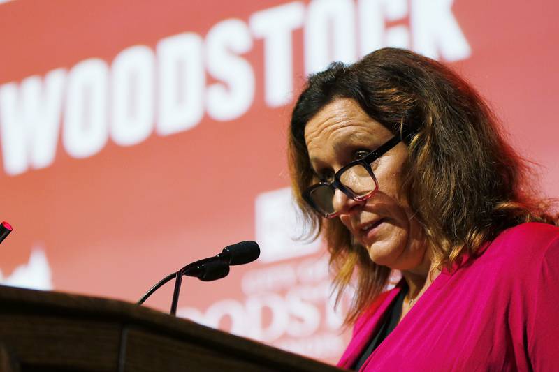 Woodstock Chamber of Commerce President and Real Woodstock Inc President Danielle Gulli speaks at the podium inside the Woodstock Opera House as she announces the city's standing among the top ten finalists in a $3 million grant from T-Mobile on Thursday, July 15, 2021, in Woodstock.