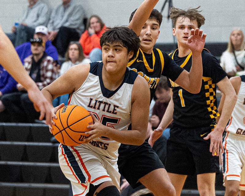 Sebastian Godinez (25) of DePue looks for open teammate for pass during game against Reed-Custer during game in the Shipyard Showdown on Tuesday, December 23, 2025 at Seneca High School in Seneca.