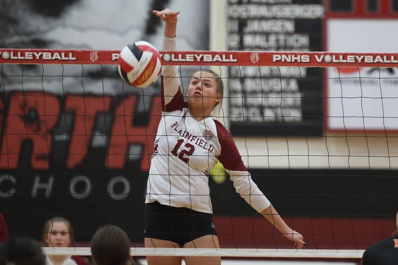 Plainfield North’s Ella Maletich scores on a ball near the net against Plainfield East on Thursday night.
