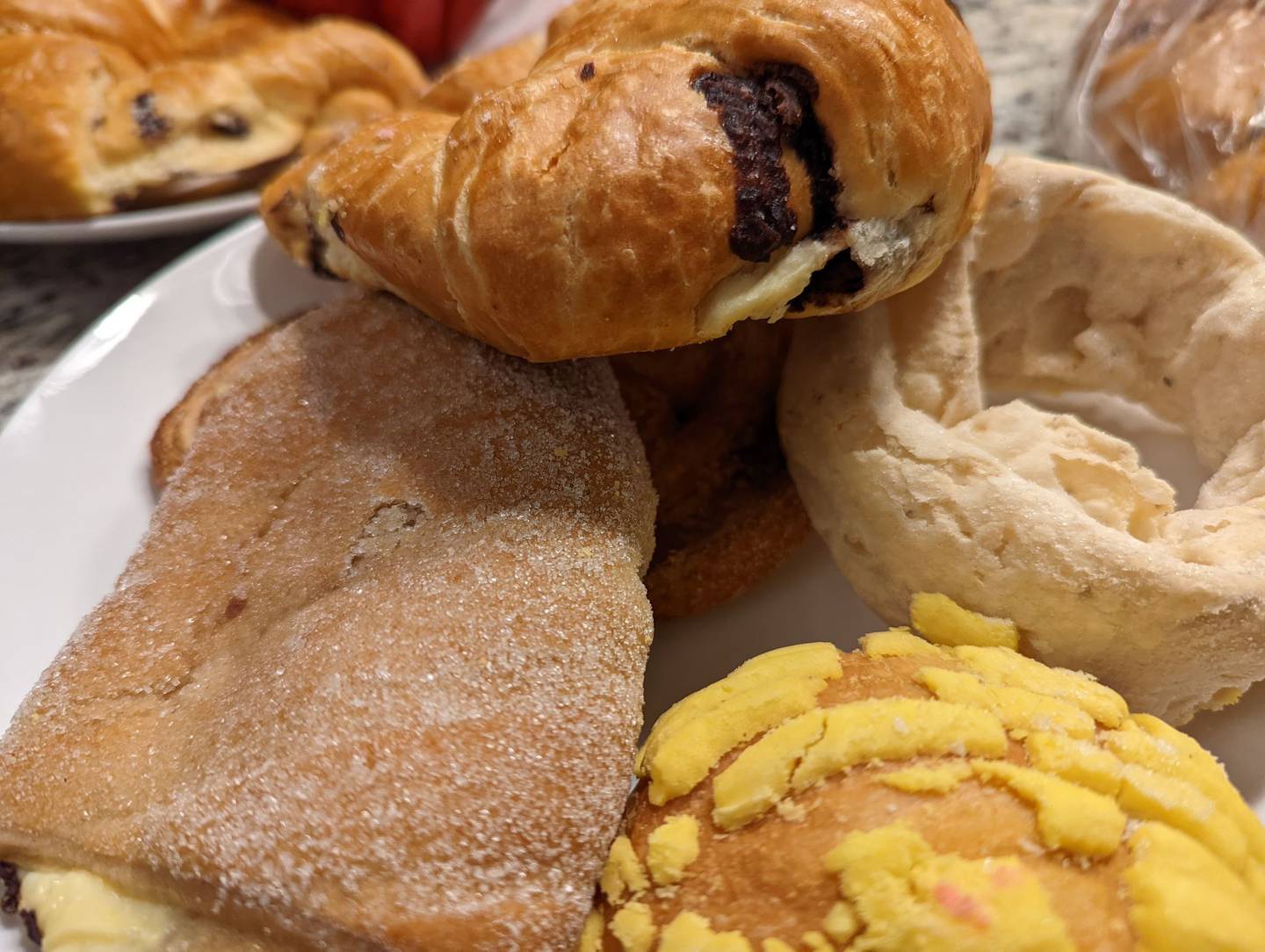 La Chicanita Bakery in Crest Hill offers a wide variety of homemade breads and pastries, juices, sandwiches and custom cakes. Pictured, clockwise, are a chocolate croissant, fried dough, concha and a cream cheese filled danish.