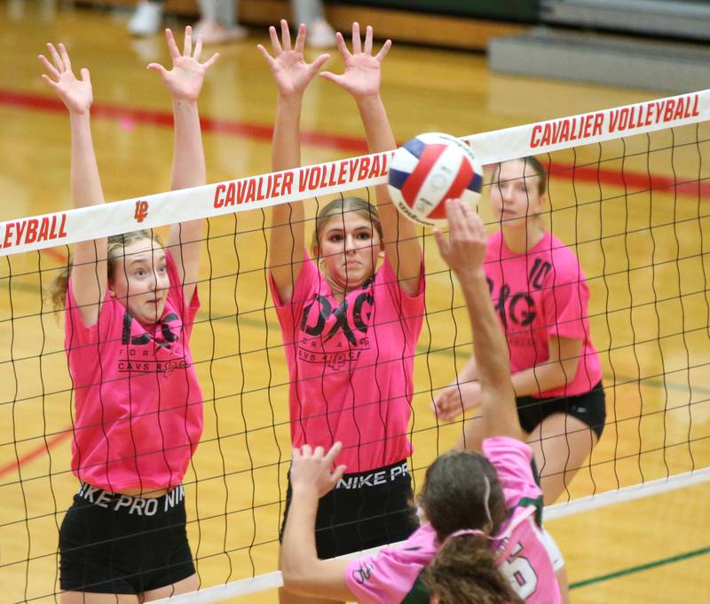 L-P players Katie Sowers, Kelsey Frederick and Olivia Weber block a spike from St. Bede's Lily Bosnich during the "Cavs 4 A Cause" pink night game on Tuesday, Sept. 26, 2023 at Sellett Gymnasium.