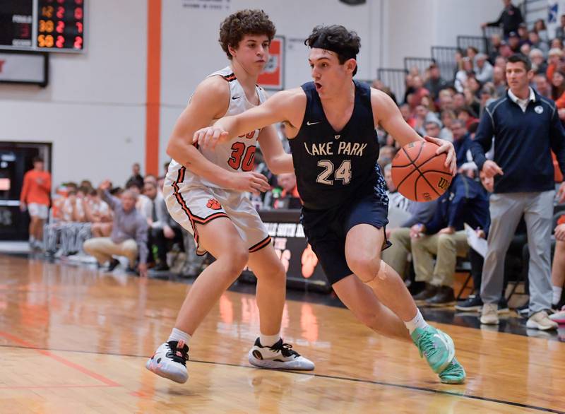 Lake Park's Dennasio LaGioia (24) drives around Wheaton Warrenville South's Luca Carbonaro (30) during a game on Saturday, Jan. 7, 2023.