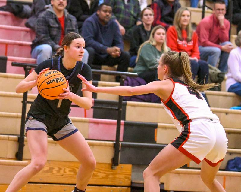 Oswego East's Aubrey Lamberti (1) looks for an open teammate during the game on Thursday Dec. 18, 2025, while being defended by Yorkville's Macie Jones (4) held at Yorkville High School.