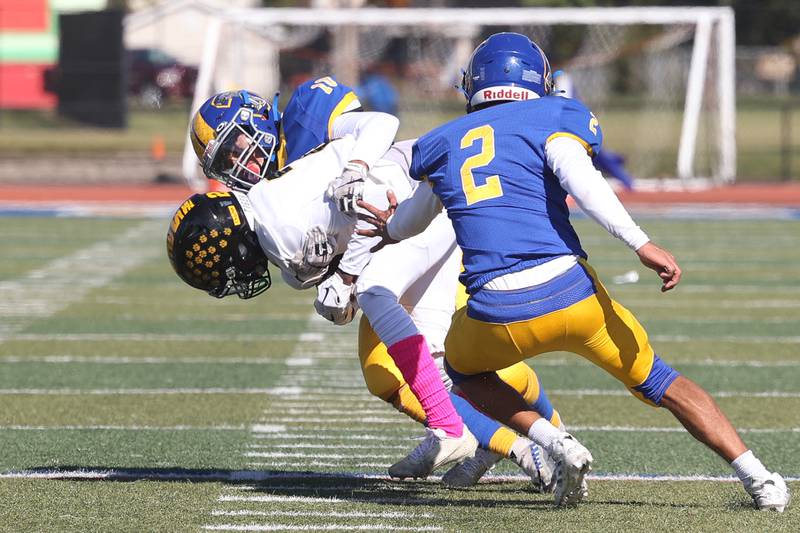 Joliet Central’s Jay Zepeda pulls down Joliet West’s Billy Bailey Jr. for a loss on Saturday.