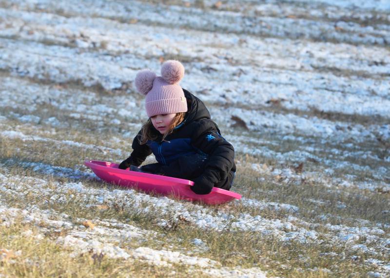 Amari Orellana, 5, of Naples, Florida, rides a saucer sled down the hill at Winter Park in Morrison on Friday, Jan. 3, 2025. Amari and her family were visiting relatives in Morrison and wanted to try sledding following the dusting of snow that fell across the region.