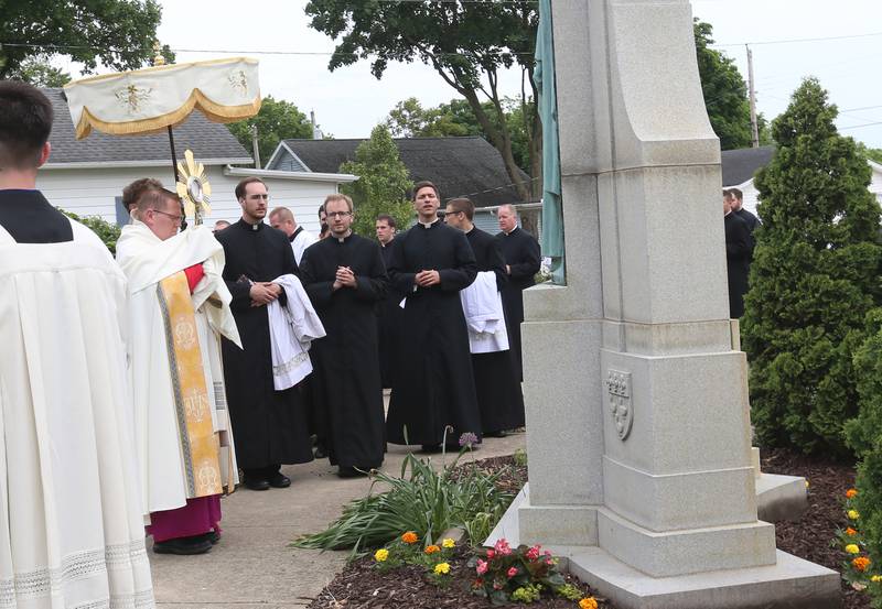 Bishop Louis Tylka leads the National Eucharistic Pilgrimage on Monday, May 19, 2025, at the Father Marquette memorial outside St. Mary's Catholic Church in Utica. The pilgrimage began in the Archdiocese of Indianapolis. It also made stops at Seneca's St. Patrick Church Queen of the Holy Rosary Shrine and St. Hyacinth Church.