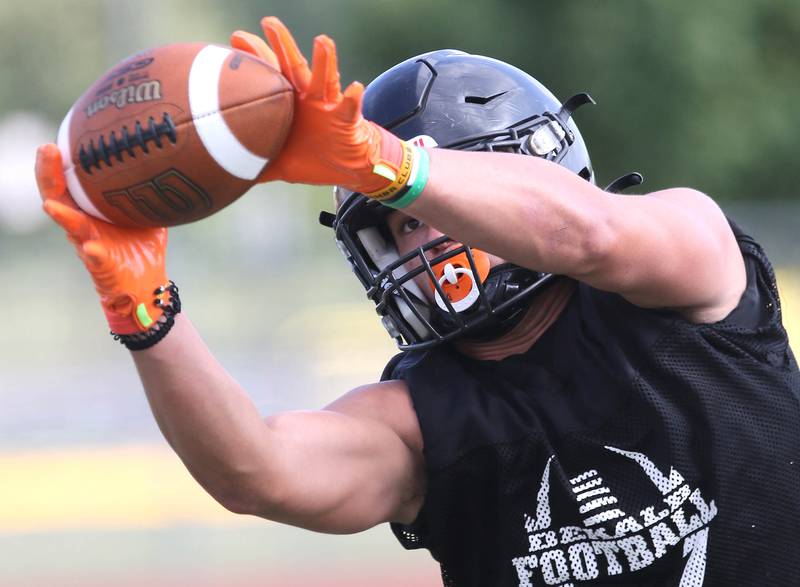 DeKalb linebacker Daniel Roman-Johnson makes an interception during a drill at practice Monday, Aug. 7, 2023, at DeKalb High School.