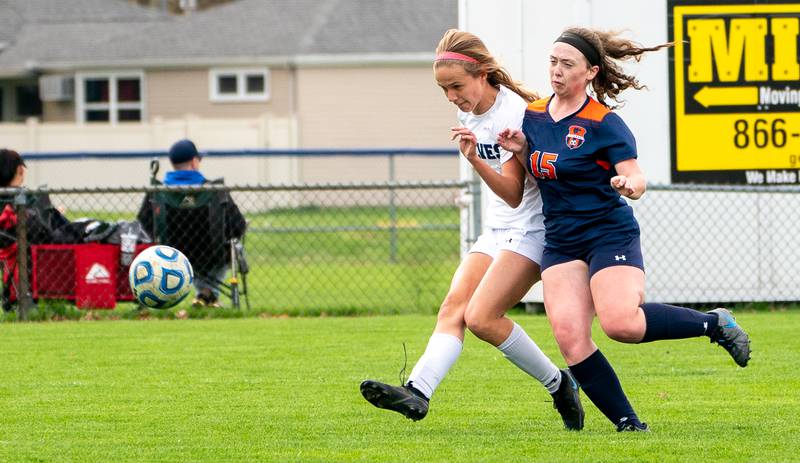 Oswego East's Anya Gulbrandsen (3) shoots the ball against Oswego’s Brynne Fehrmann (15) (15) for a goal during a soccer match at Oswego High School on Monday, May 2, 2022.