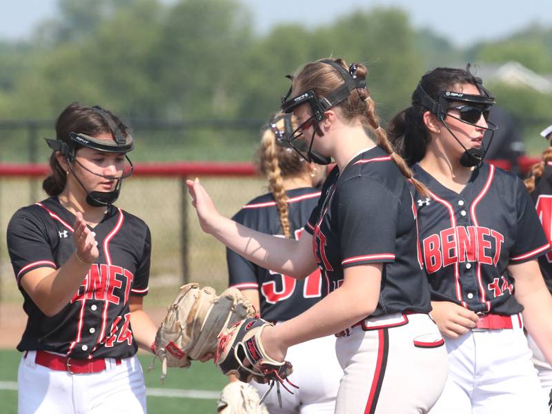 Members of the Benet Academy softball team gather on the mound between innings during the Class 3A State third place game on Saturday, June 10, 2023 at the Louisville Slugger Sports Complex in Peoria.