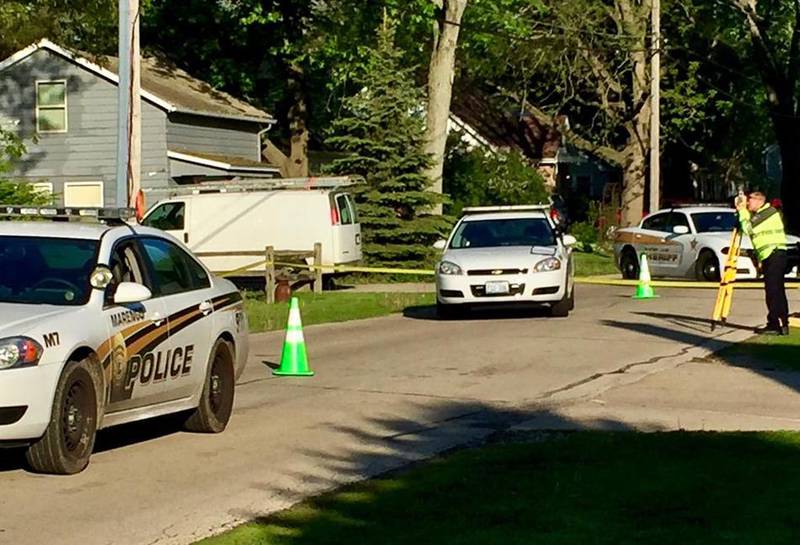 A police officer takes measurements outside a home at 709 E. Prairie St. in Marengo on Sunday morning after an incident where a Marengo officer shot an allegedly armed boy on Saturday night.