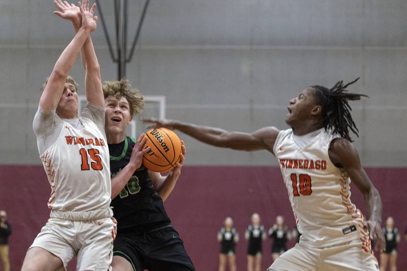 Rock Falls’ Kuitim Heald works against Winnebago’s Mitchel Cunningham (left) and Myles Smith Tuesday, March 4, 2025, during the 2A boys basketball Sectional final at Marengo.