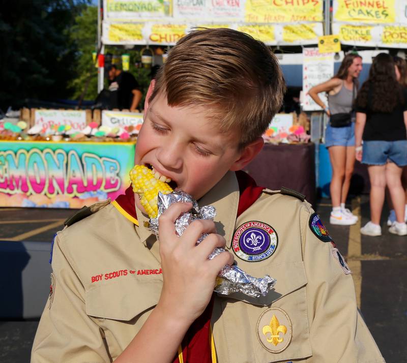 Lane Westerhaus of Sugar Grove enjoys an ear of corn at the 2024 Sugar Grove Corn Boil on Friday, July 26, 2024.