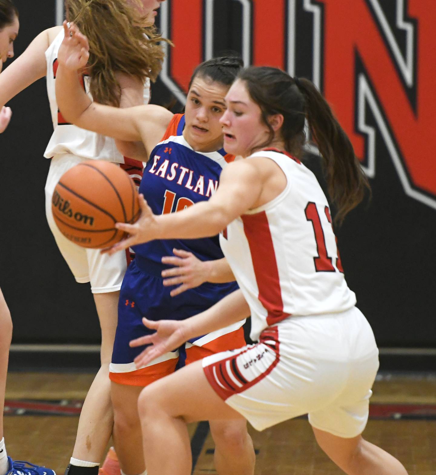Eastland's Paige Joiner (10) and Forreston's Brooke Boettner (11) reach for a loose ball during a NUIC game on Friday, Feb. 3 in Forreston.
