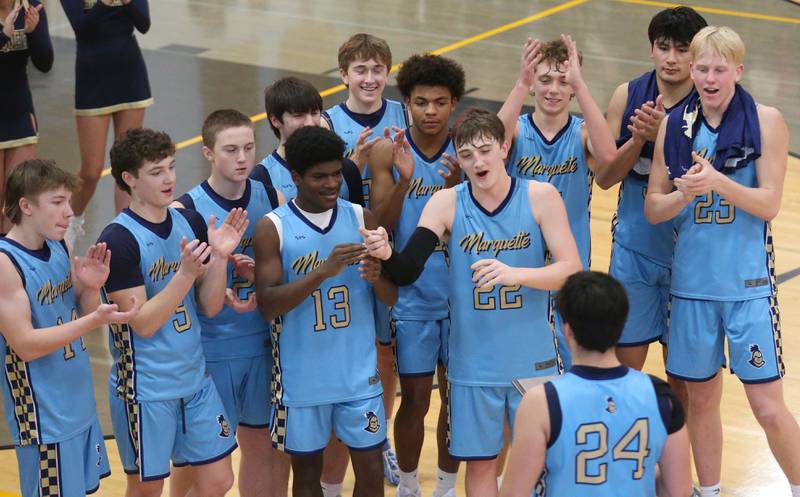 Members of the Marquette boys basketball team celebrate after winning the 99th annual Tri-County Conference Championship on Friday, Jan. 30, 2026 at Putnam County High School.