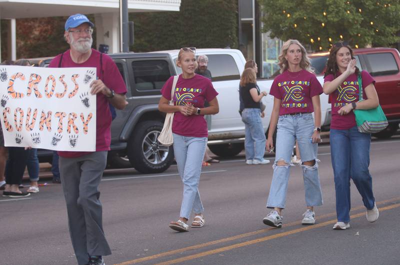 Members of the Princeton High School cross country team walks in the homecoming parade on Thursday, Sept. 25, 2025 along South Main Street in Princeton .