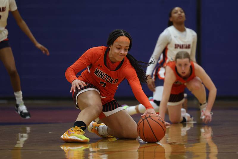 Minooka’s Kennedi Brass slides to recover the loose ball against Romeoville on Tuesday January 24th, 2023.