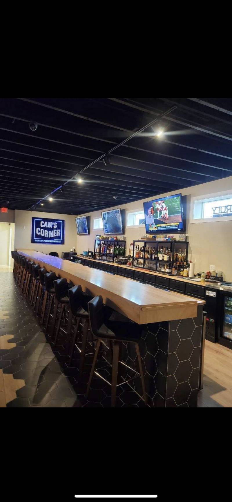 Tyler Lewis and his wife, Abby, recently opened sports bar Cam’s Corner in Naplate.