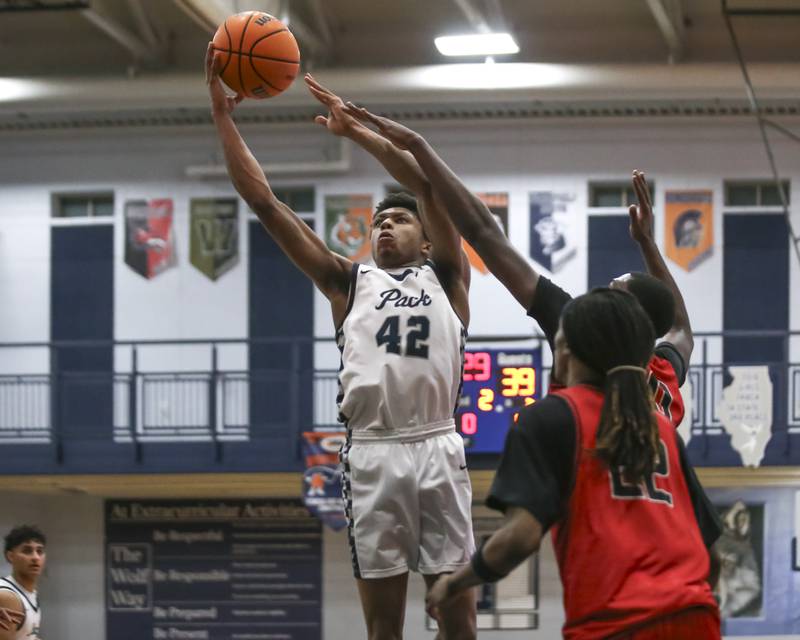 Oswego East's Dshaun Bolden (42) goes in for a layup during their basketball game between Bolingbrook at Oswego East Friday, Jan 30, 2026 in Oswego.