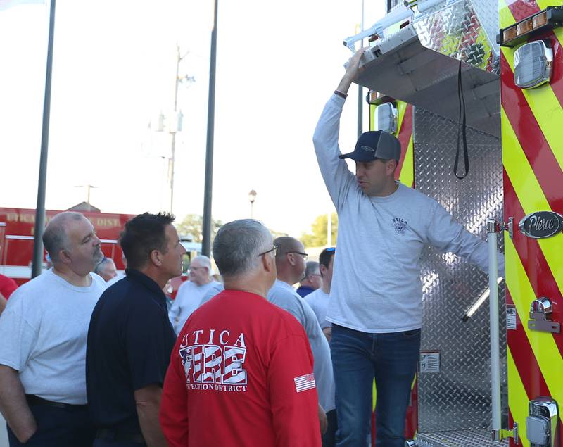 Utica Fire Chief Ben Brown (right) climbs down from the back of the new Pierce Heavy Duty Rescue Truck at the Utica Fire Station on Thursday, Sept. 14, 2023. The $706,000.00 truck will replace a 28 year old rescue truck. The new vehicle will have equipment to handle water rescue, industrial accidents and grain bin emergencies. The department hopes to have it in operation on Columbus Day weekend.