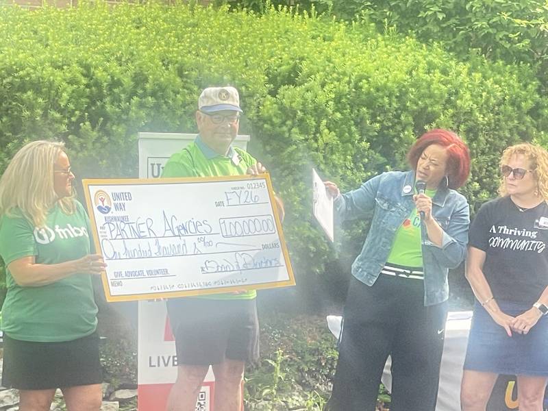 Kishwaukee United Way executive director Michele Vaughn (second from right) points to a $100,000 check on Thursday, June 12, 2025. The money will aid partner agencies that provide services to local residents during fiscal year 2026.