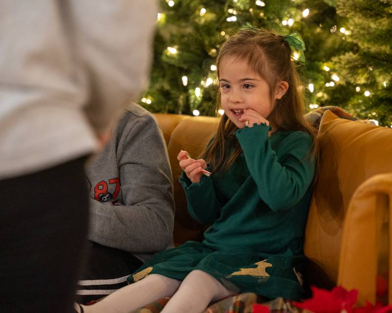 Ayva Widolff eats candy cane before posing for photo with Santa on Sunday, December 14, 2025 at The Coffee Barn in Mendota.