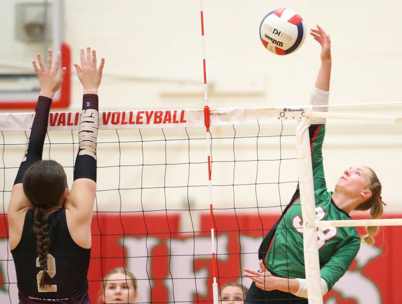 L-P's Aubrey Duttlinger sends a kill past Morris's Alexis Williams on Thursday, Oct. 10, 2024 in A.J. Sellett Gymnasium at L-P High School.