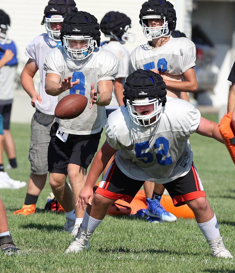 Genoa-Kingston's Nolan Perry takes the snap Wednesday, Aug.10, 2022, during practice at the school in Genoa.