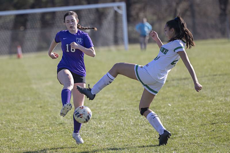 Dixon’s Emily Smith and North Boone’s Julia Garbacz work for the ball Thursday, April 6, 2023.