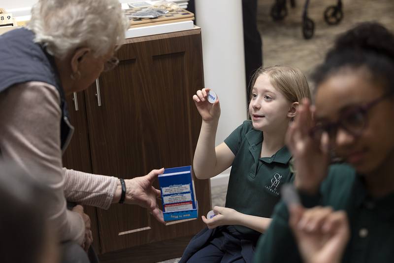 Joyce Hussung and St. Andrews student Janina engage in a game Thursday, Jan. 30, 2025, at Morningside of Sterling senior living facility.