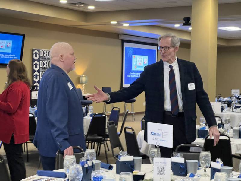 Interim DeKalb County Administrator Derek Hiland talks with DeKalb City Manager Bill Nicklas on Dec. 2, 2025, at a DeKalb County Economic Development Corporation event in DeKalb.