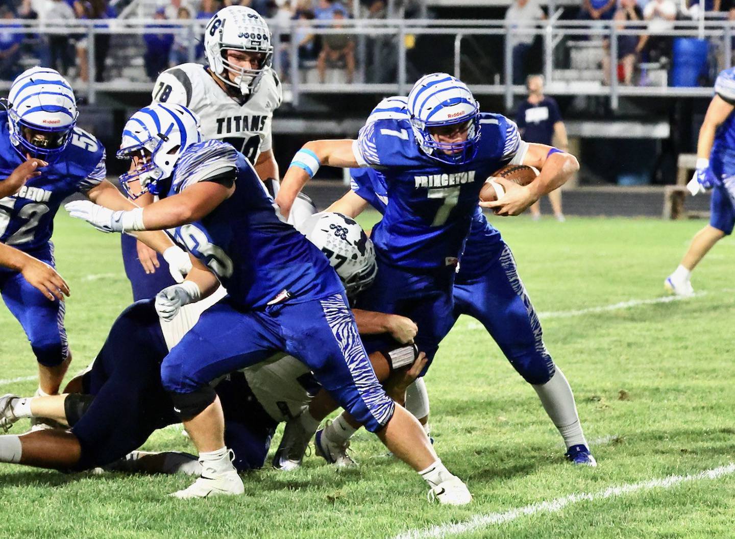 Princeton senior quarterback Gavin Lanham fights for yards in Friday's homecoming game at Bryant Field against Monmouth-Roseville. The Titans won 36-6.